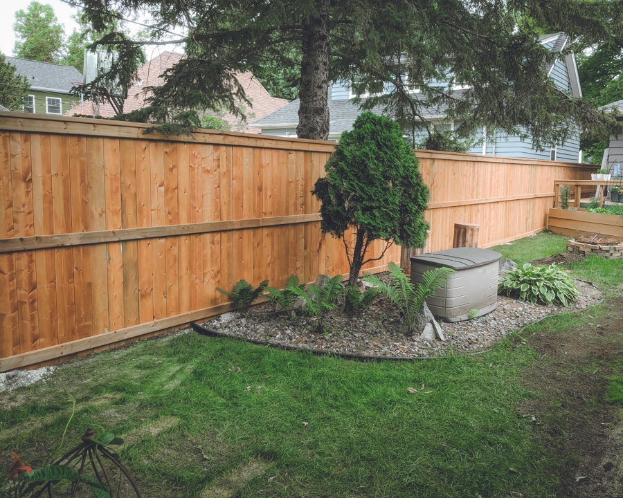 Recently renovated backyard wooden fence with great landscaping.