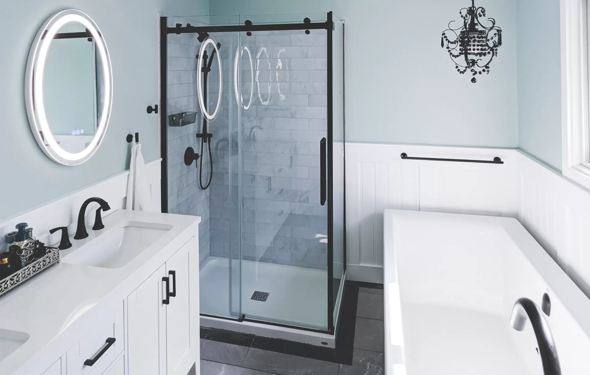 A newly renovated bathroom with a vanity, shower and bath tub by BZ Carpentry Services in Winnipeg.